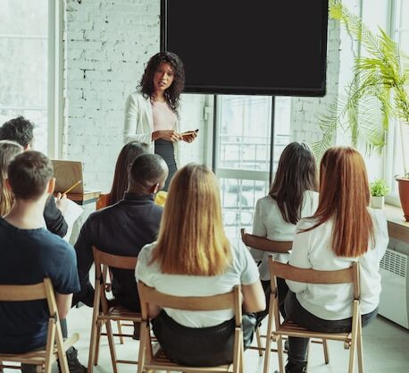 attachment-https://beigemarvelbakery.com/wp-content/uploads/2024/09/female-african-american-speaker-giving-presentation-hall-university-workshop_155003-3579-458x417.jpg